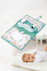 Bebek alt değiştirme çantası içinde bezler, krem ve ıslak mendil ile yerde yatıyor