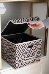 El ile açılan desenli kumaş saklama kutusu, modern dolap içinde yer alıyor