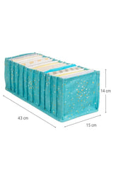 Turkuaz renkli, altın ve beyaz yıldız desenli katlanabilir düzenleyici kutu, içinde kıyafetler, ölçüler 43x15x14 cm