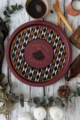 Sirkus temalı dekoratif tepsi, kahve fincanı, ekmek çubukları ve mumlarla rustik ahşap masada